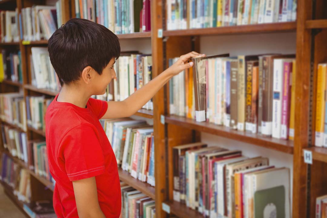Student looking at books in a library