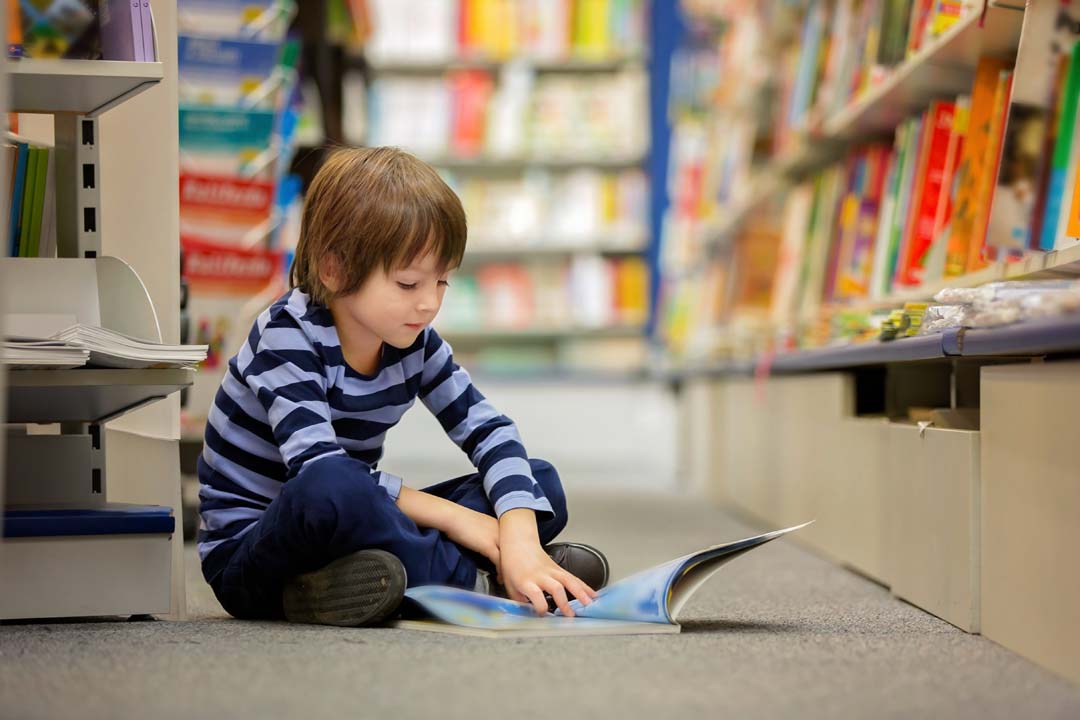 Student in the library reading a book