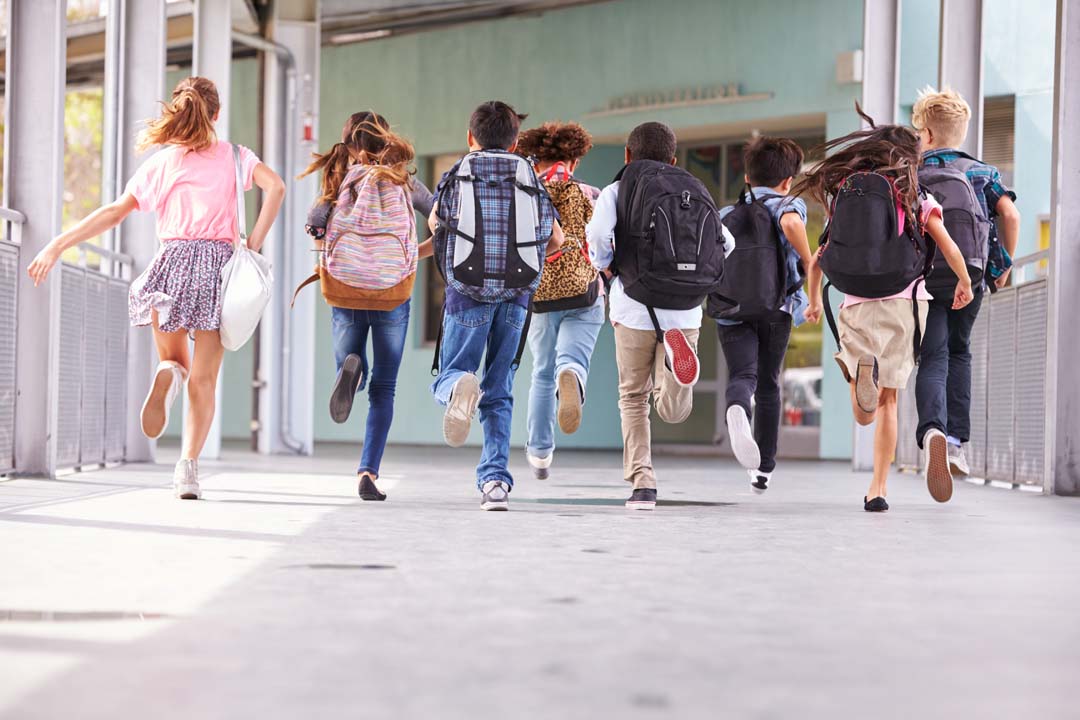 students running in the school hallway