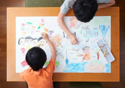 Students drawing with crayons