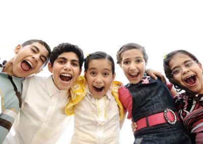 Happy children group laughing in camera, outdoor