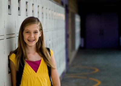 Student next to a row of lockers