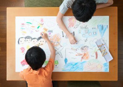Students drawing with crayons