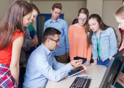 students listening to demonstration by a teacher