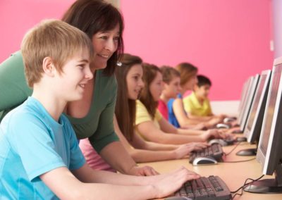 Students and a teacher in a computer lab