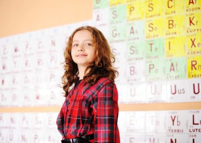 school children at class with periodic table of the elements