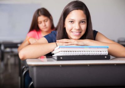 high school student enjoying class and smiling