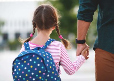 Adult and child walking to school