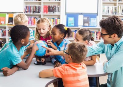 Teacher and students discussing world geography